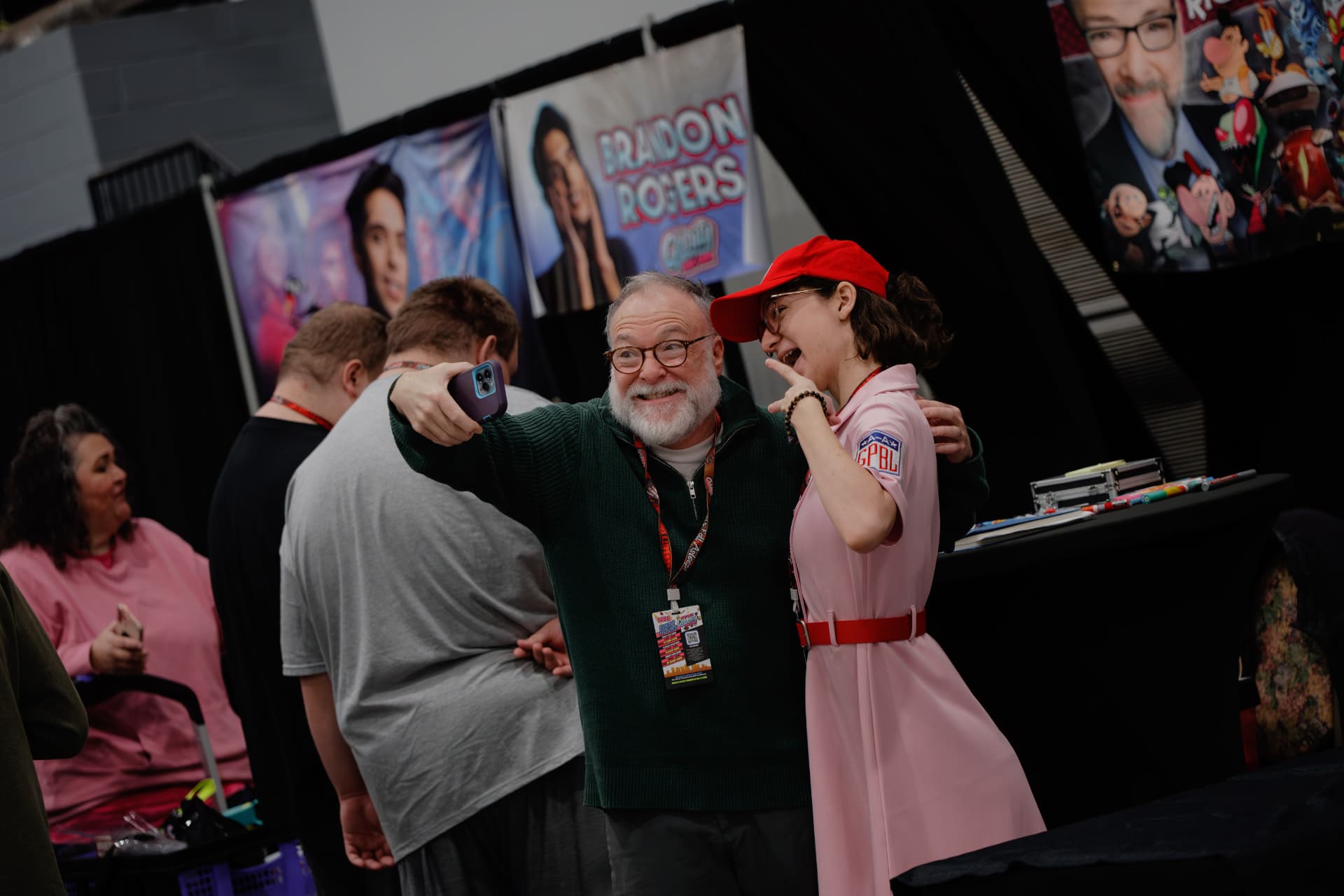A guest taking a selfie with a fan in costume