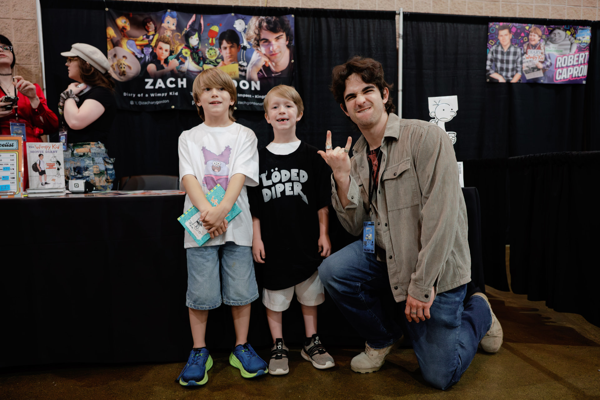 Zachary Gordon posing with two young fans