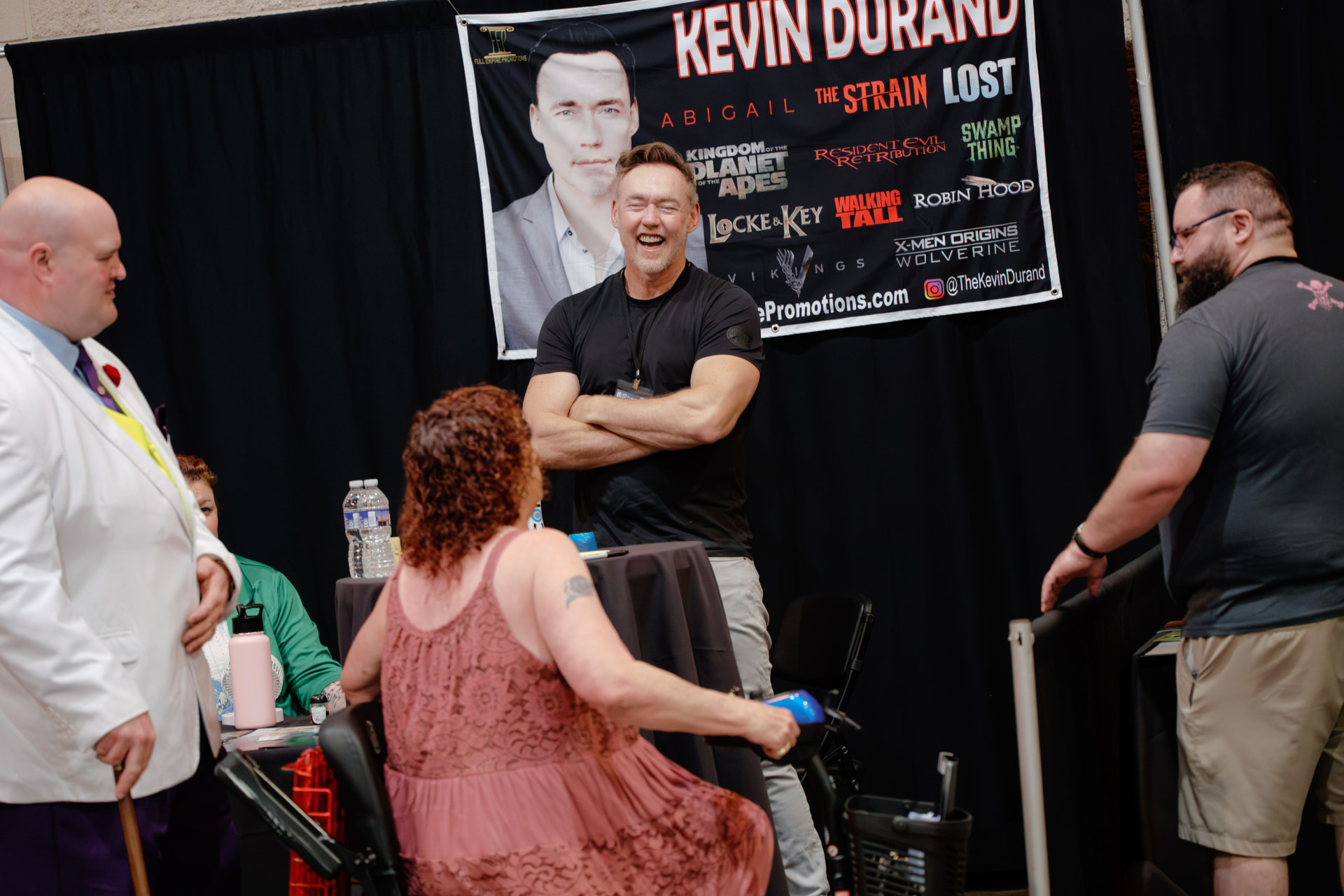 Kevin Durand laughing with fans at his booth